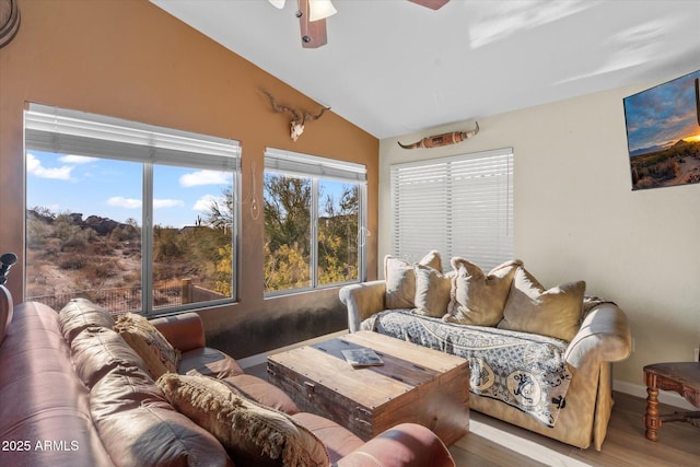 living room featuring ceiling fan, a healthy amount of sunlight, vaulted ceiling, and wood-type flooring