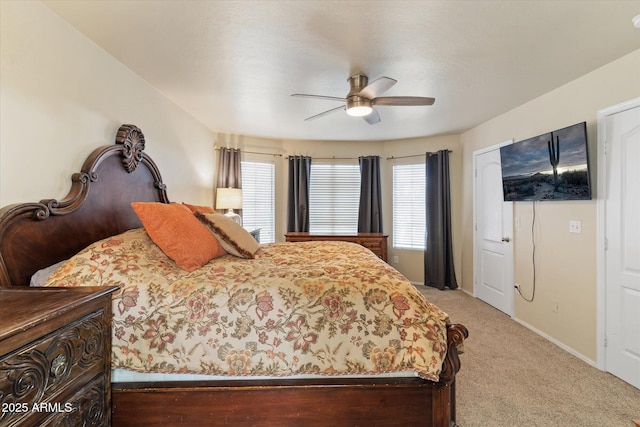 carpeted bedroom with multiple windows and ceiling fan