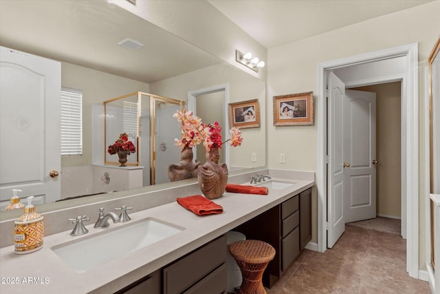 bathroom featuring a shower with door and vanity