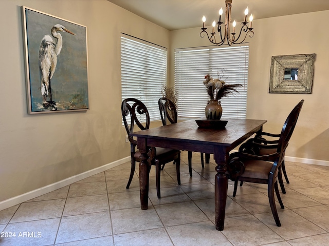 tiled dining room featuring a notable chandelier