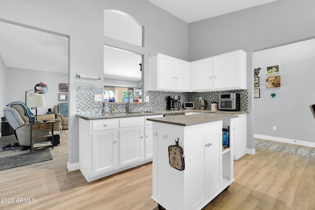 kitchen featuring a sink, white cabinets, and tasteful backsplash