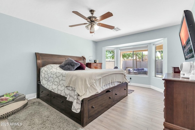 bedroom featuring visible vents, baseboards, a ceiling fan, and wood finished floors
