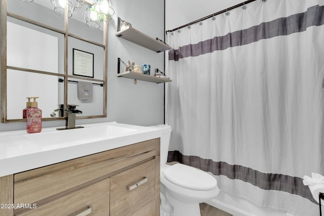 full bath with curtained shower, vanity, and toilet