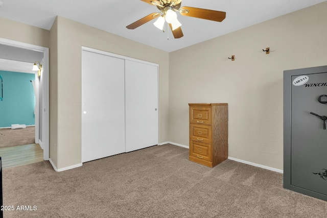 unfurnished bedroom with a closet, ceiling fan, baseboards, and carpet