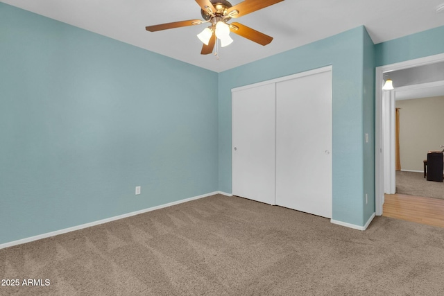 unfurnished bedroom featuring a closet, baseboards, a ceiling fan, and carpet flooring