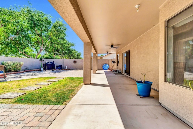 view of patio with a fenced backyard and a ceiling fan