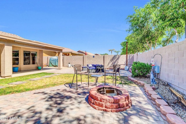 view of patio / terrace featuring a fenced backyard and a fire pit