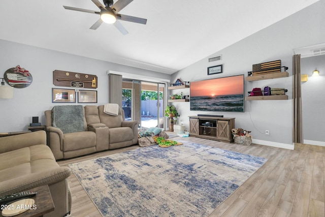 living area featuring visible vents, baseboards, ceiling fan, wood finished floors, and vaulted ceiling