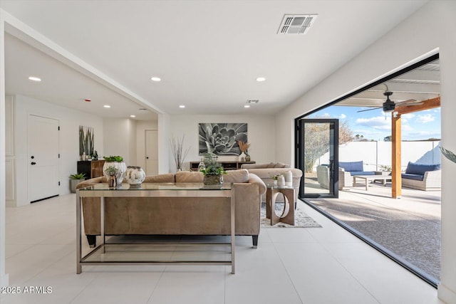 tiled living room with ceiling fan