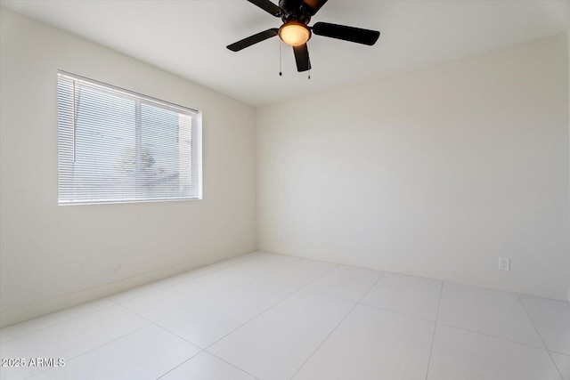 tiled empty room with ceiling fan