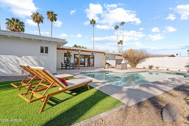 view of pool featuring a lawn, ceiling fan, and a patio