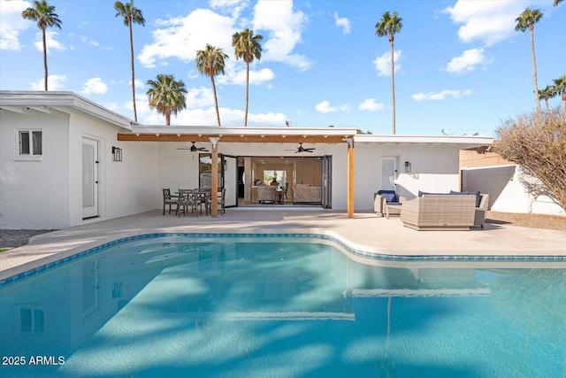 view of pool featuring a patio area, ceiling fan, and an outdoor living space