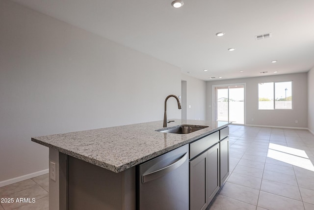 19115 N Los Gabrieles Way, Maricopa, AZ 85138 - kitchen featuring dishwasher, a sink, light tile patterned floors, a center island with sink, and light stone countertops