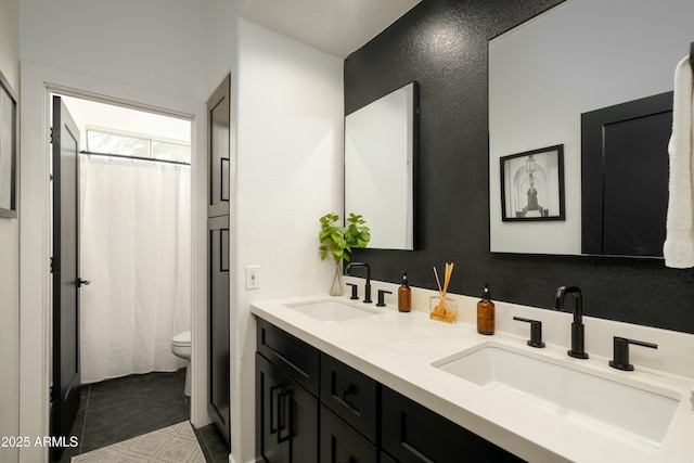 bathroom featuring tile patterned floors, vanity, and toilet