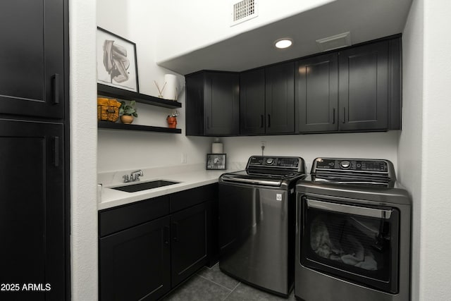 laundry room featuring independent washer and dryer, cabinets, light tile patterned floors, and sink