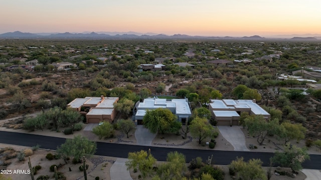 aerial view at dusk featuring a mountain view