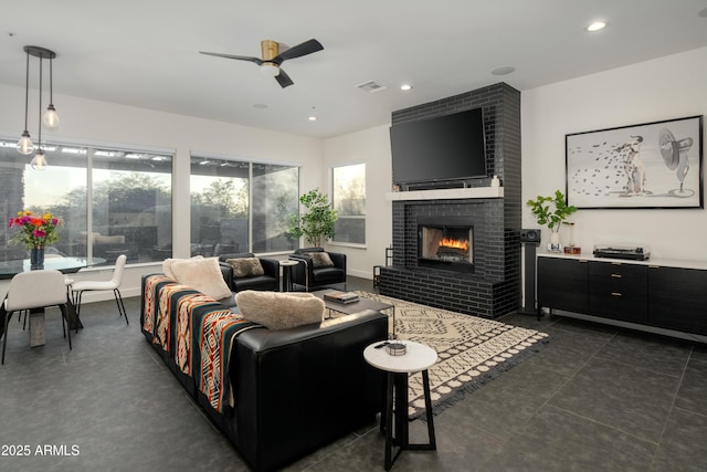 living room with a brick fireplace and ceiling fan