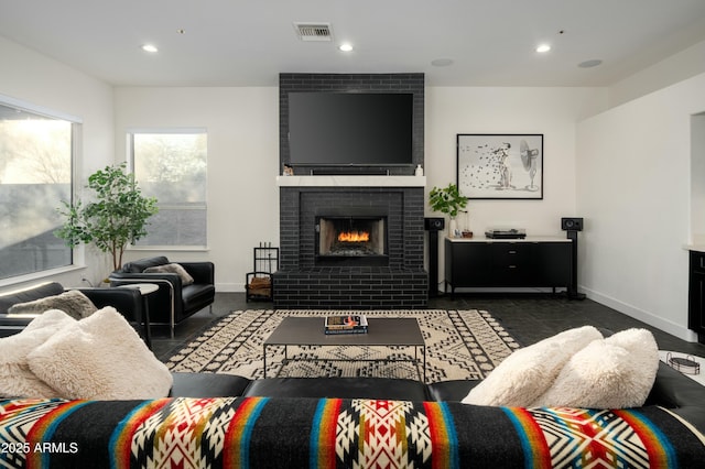 living room with a brick fireplace