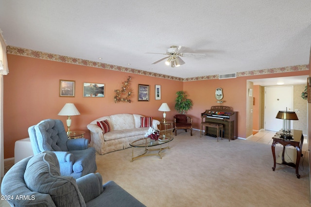 living room with light colored carpet, a textured ceiling, and ceiling fan