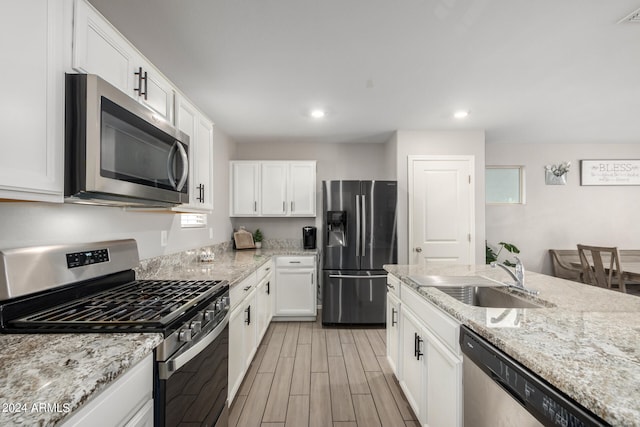 kitchen featuring white cabinets, light hardwood / wood-style flooring, stainless steel appliances, and sink