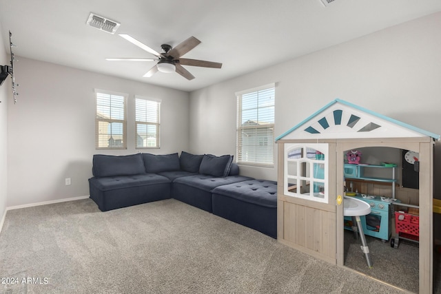 carpeted living area with a ceiling fan, visible vents, and baseboards