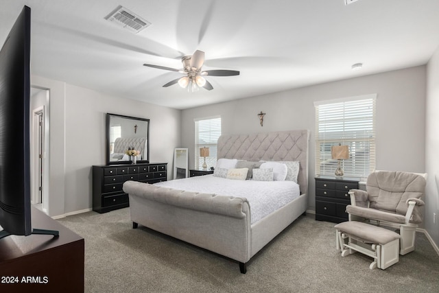 bedroom with baseboards, ceiling fan, visible vents, and light colored carpet