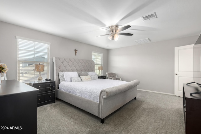 bedroom featuring multiple windows, ceiling fan, and carpet floors