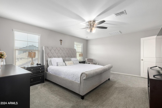 bedroom featuring a ceiling fan, light colored carpet, visible vents, and baseboards