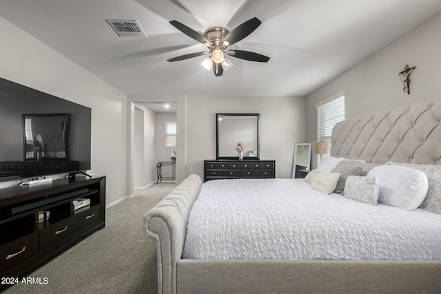 bedroom with carpet floors, a ceiling fan, visible vents, and baseboards