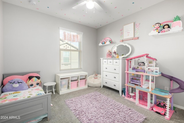 carpeted bedroom with ceiling fan and baseboards