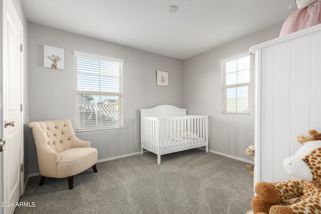 bedroom with carpet and a crib