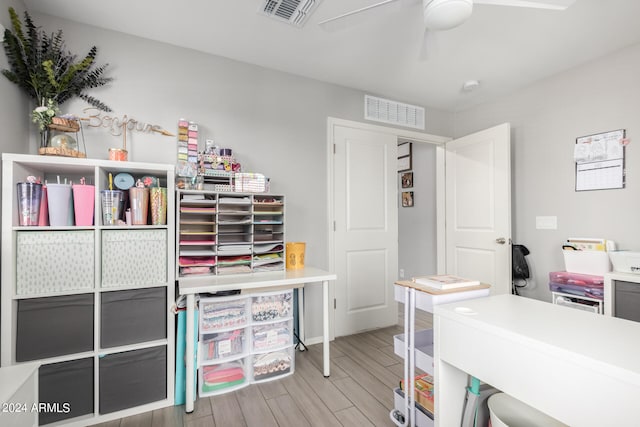 home office featuring ceiling fan and light hardwood / wood-style floors