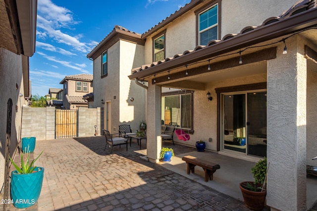 view of patio with a gate and fence