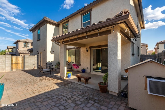 back of property featuring a patio area, fence, and stucco siding