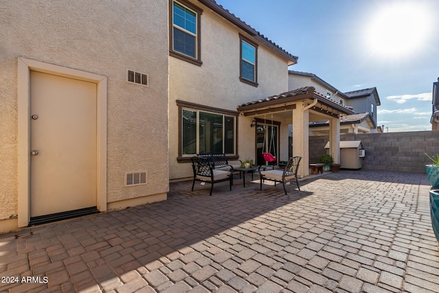 view of patio / terrace featuring fence and visible vents