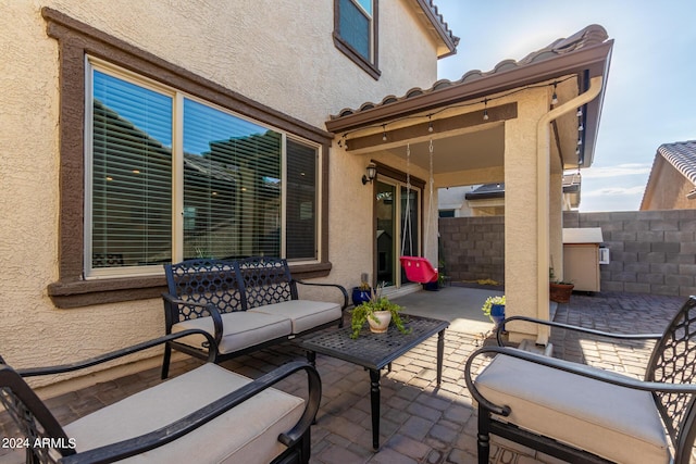 view of patio featuring fence and an outdoor living space