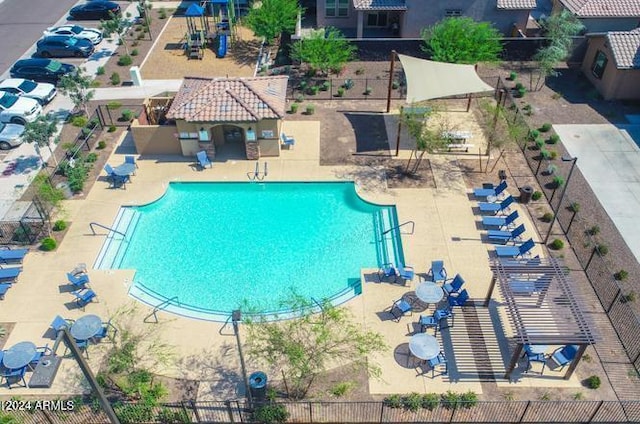 view of swimming pool featuring fence and a patio