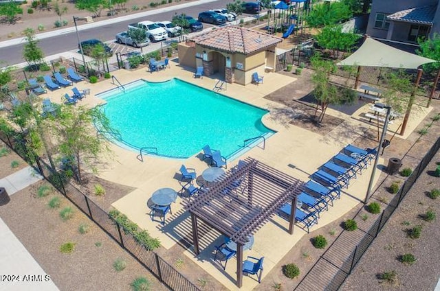 pool featuring fence, a pergola, and a patio