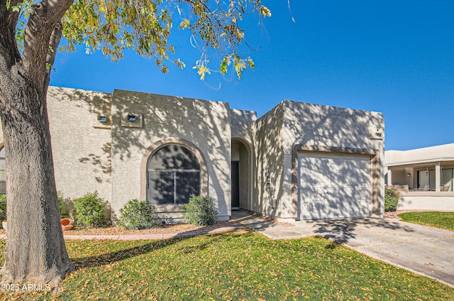 view of front of house with a garage and a front lawn