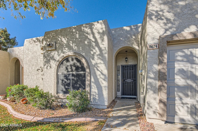 view of exterior entry featuring a garage