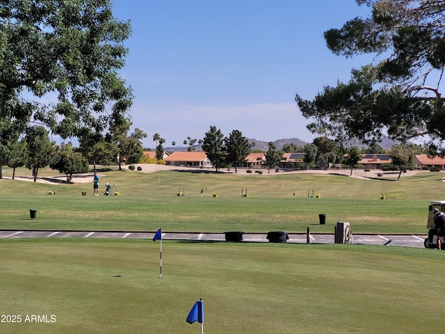 view of home's community featuring a mountain view and a yard