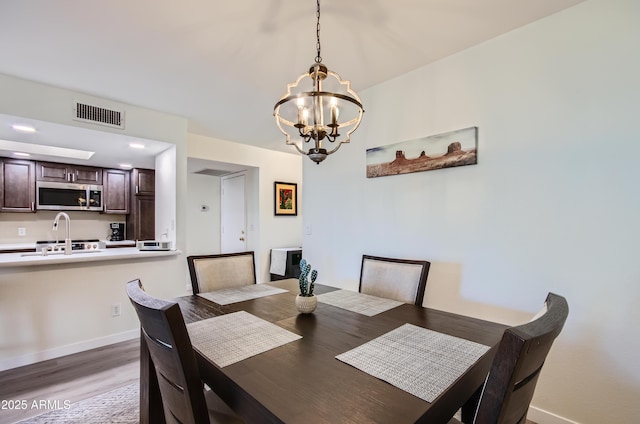 dining room featuring a notable chandelier and light wood-type flooring