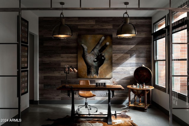 interior space featuring wood walls and concrete floors