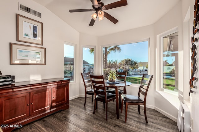 dining room featuring ceiling fan, lofted ceiling, and dark hardwood / wood-style flooring