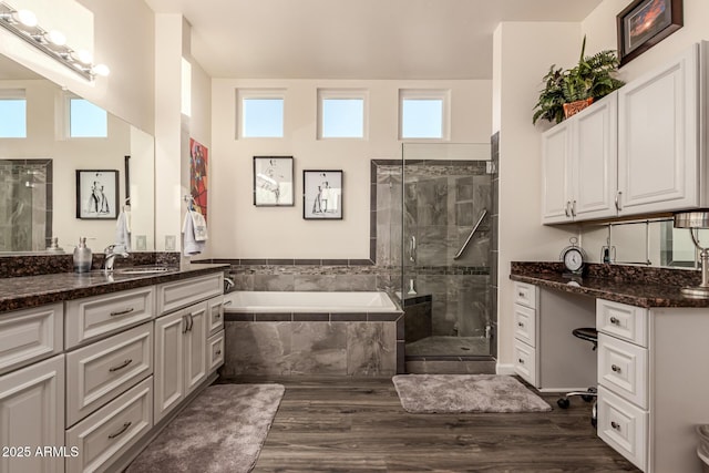 bathroom with hardwood / wood-style flooring, a healthy amount of sunlight, vanity, and independent shower and bath