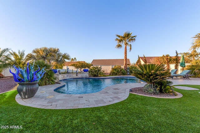 view of swimming pool with a yard and a patio area