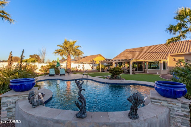 view of pool featuring a yard and a patio