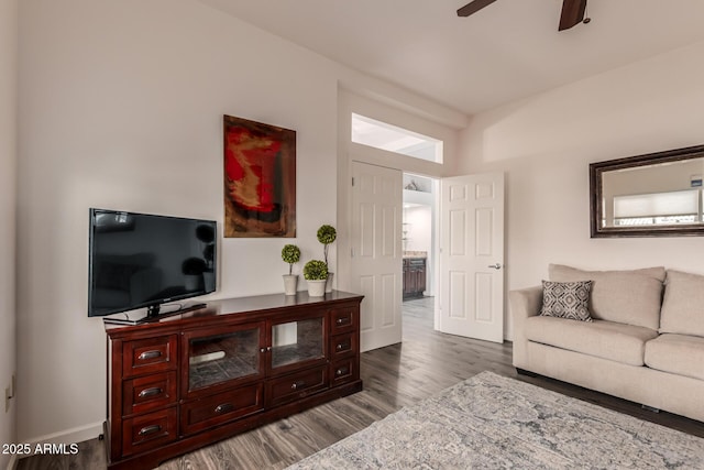 living room featuring hardwood / wood-style floors and ceiling fan