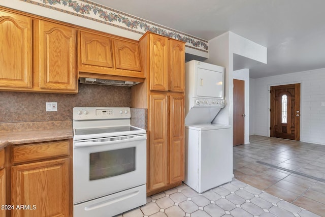 kitchen with decorative backsplash, light tile patterned floors, white electric stove, stacked washer and dryer, and range hood