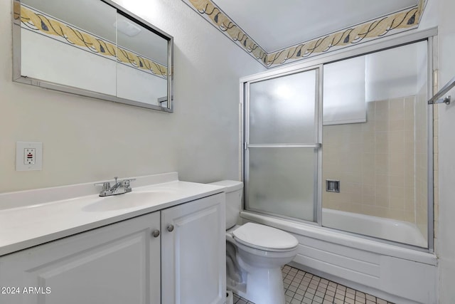 full bathroom with tile patterned flooring, vanity, toilet, and enclosed tub / shower combo